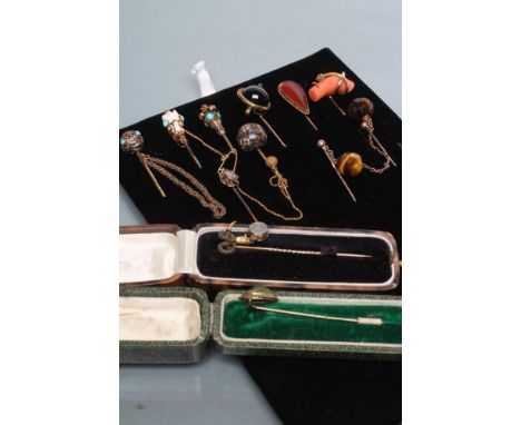 A COLLECTION OF NINE VICTORIAN AND LATER STICK PINS including a scarab, plaited hair snake with locket, banded agate, coral t