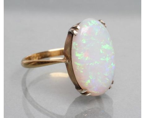 AN OPAL DRESS RING, the oval polished stone claw set to a plain shank, stamped PLAT, 18ct, size P 1/2 (Est. plus 21% premium 