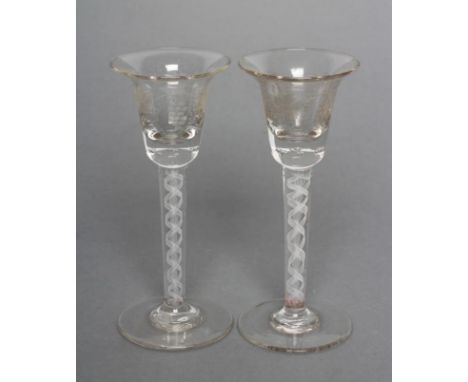 A PAIR OF WINE GLASSES, the bell bowls engraved with fruiting vines on double series opaque white twist stems, the centre gau