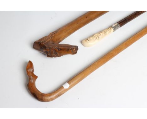 A LADY'S VICTORIAN WALKING CANE, the bamboo shaft with silver(?) collar (marks rubbed), the ivory grip carved with owls with 