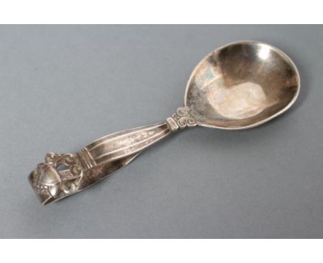 A GEORG JENSEN SILVER CADDY SPOON, London import marks 1957, in Lotus pattern, 4" long (Est. plus 21% premium inc. VAT)24.6g,