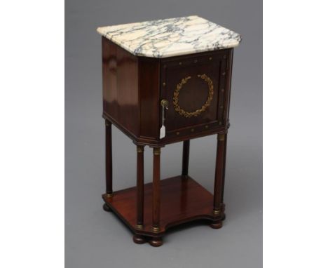 A FRENCH EMPIRE STYLE MAHOGANY BEDSIDE COMMODE of canted oblong form with gilt metal mounts, moulded veined white marble top 