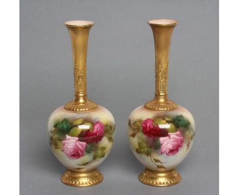 A PAIR OF ROYAL WORCESTER CHINA BUD VASES, 1917, with tall acanthus sheathed flared stems issuing from globular bodies on a l