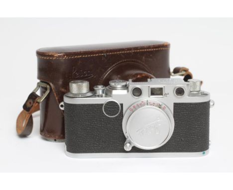 A LEICA CAMERA, No. 799099, IIF, red dial, with lens cover, original stitched leather case, together with some accessories an