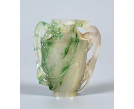 A CHINESE JADE BOTTLE, the flattened ovoid body with two elongated mythical beast carved handles, 3" high (Illustrated) (Est.