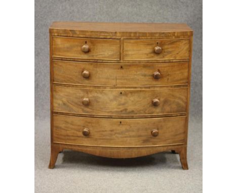 A REGENCY MAHOGANY BOWED CHEST, early 19th century, the caddy top over two short and three long cockbeaded drawers with turne