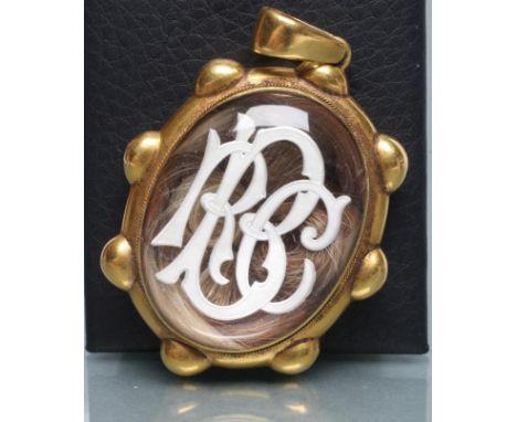 A VICTORIAN MOURNING PENDANT, the unmarked oval beaded frame enclosing a two colour strand plaited hair panel, the fascia int