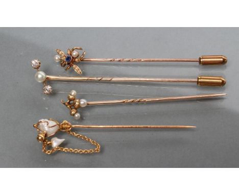 A COLLECTION OF FOUR VICTORIAN AND LATER STICK PINS including a fly with sapphire head and seed pearl wings and a seed pearl 