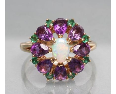 A GEM SET FLOWERHEAD COCKTAIL RING, the oval cabochon polished opal claw set to a border of eight amethyst petals with eight 