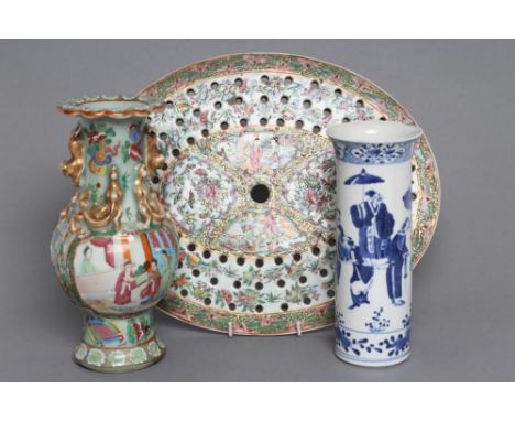 A CANTONESE PORCELAIN OVAL STRAINER painted in famille rose enamels with two panels of figures on a foliate ground, 13 1/4" x