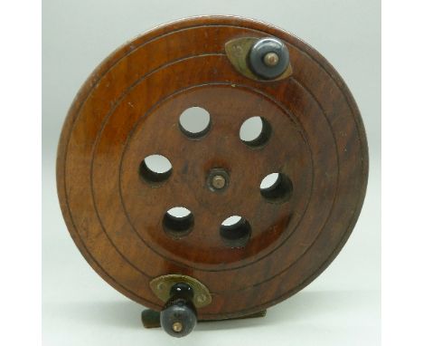 A Scarborough wooden sea fishing reel, stamped Eton Sun, diameter 18cm, 7"