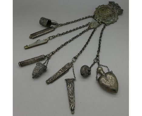 A metal chatelaine with Victorian silver comb, a Victorian silver heart-shaped scene and other Victorian silver attachments