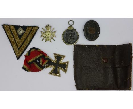 A German Knight Cross, a German Russian Winter Campaign medal, an Afrika Korps long service chevron patch, a German badge and