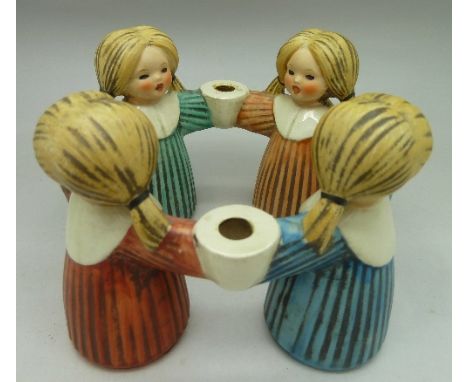 A Goebel Germany candle holder in the form of four girls holding hands