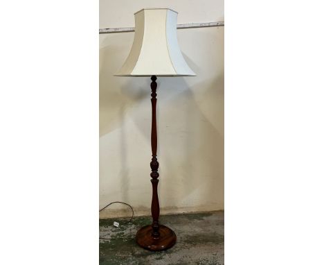A mahogany turned floor standing lamp 