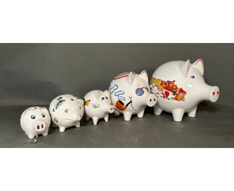 A selection of vintage white painted piggy banks. Various ages and sizes