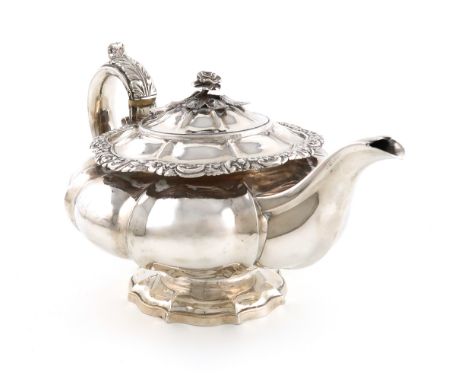 λA George IV silver teapot, by Emes and Barnard, London 1826, circular lobed form, leaf-capped scroll handles with ivory insu