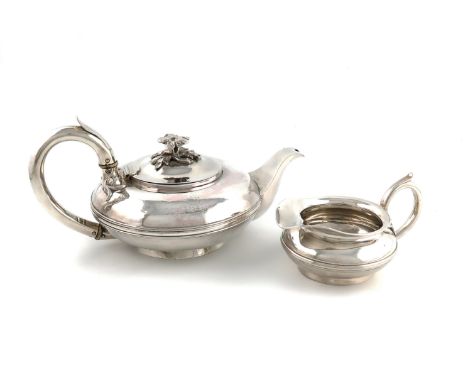 λA William IV silver teapot and matching cream jug,by John E. Terrey, London 1832,compressed circular form, scroll handle wit