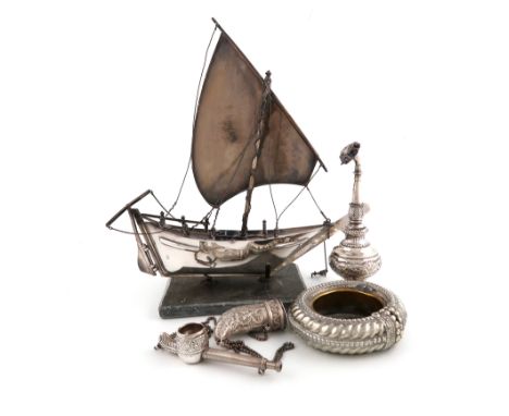 A collection of Middle-Eastern metalware items,comprising: a model of a sailing dhow, with a single mast, rudder, anchor and 