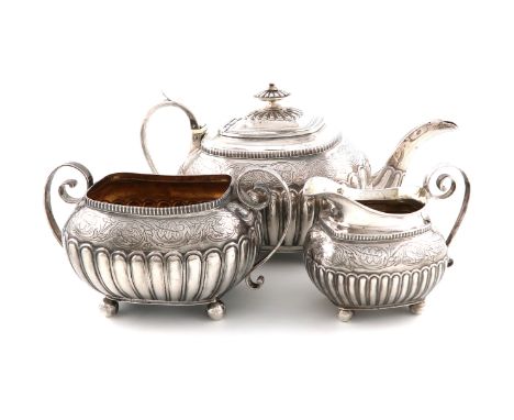 λA George III silver teapot, together with a cream jug and sugar bowl, the teapot by Solomon Hougham, London 1810, the cream 