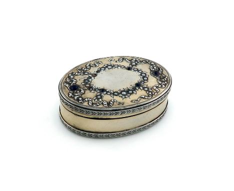 A French silver snuff/pill box,retailed by Boucheron, Paris,oval form, the hinged cover with foliate decoration, seed pearls 