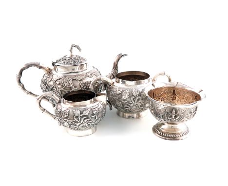 A three-piece Chinese metalware tea set,marked 90 and possibly T.P,circular form, shared foliate decoration on a matted backg