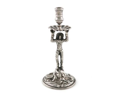 A George II cast silver harlequin taper stick, maker's mark worn, London 1752, the standing harlequin with raised arms holdin