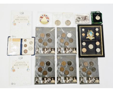 A mixture of coin related items to include a framed set of pre decimal coins, 2 x Miss Potter 50p collection albums (empty), 