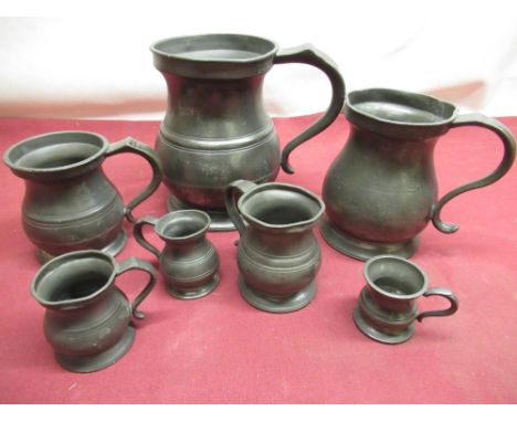 Set of seven Pewter measuring cups 