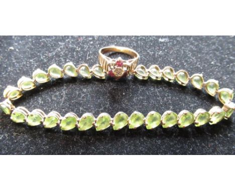 10ct yellow gold mounted articulated bracelet with tear drop green stones, with a box clasp stamped 10K, L19cm and a hallmark