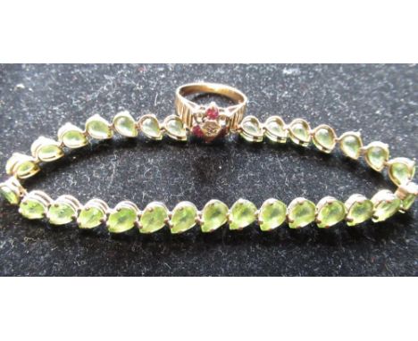 10ct yellow gold mounted articulated bracelet with tear drop green stones, with a box clasp stamped 10K, L19cm and a hallmark