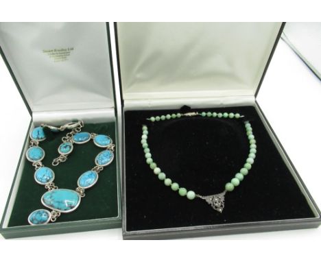 Jade bead necklace, single string with  marcasite set white metal central decoration and marcasite set silver fish hook clasp