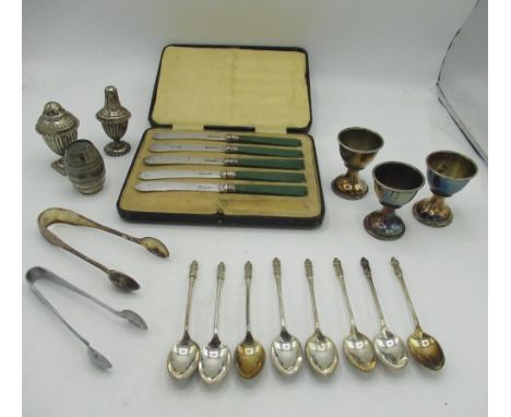 Cased set of five green handled knives, eight apostle tea spoons, salt and pepper set, two pairs of sugar nips, egg cups etc 