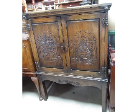 C20th oak cocktail cabinet, fitted interior with two carved panel doors, W92cm D45cm H123cm 