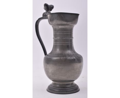 A mid century Swiss pewter tankard / pitcher jug. The jug featuring an acorn finial to the top of the hinged lid over a bulbo