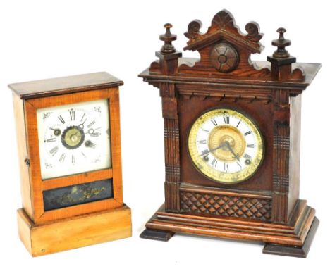 A late 19thC American pine cased mantel clock, with a tin dial bearing Roman numerals, the movement with alarm bell function,