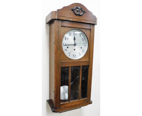 An oak cased wall clock, with Arabic numeral dial, eight day movement with Westminster chime, 80cm high.