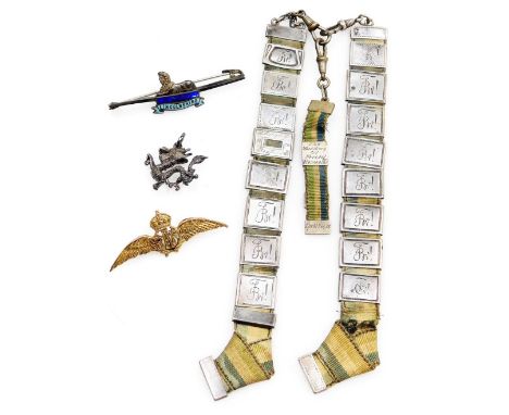 A 9ct gold RAF wings sweetheart brooch, 4.0g, a silver and enamel Lincolnshire Regiment badge, a dragon pendant and a German 