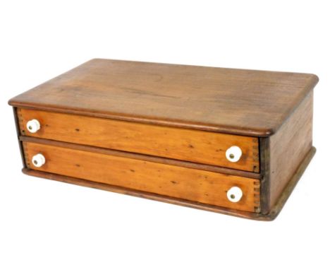 An early 20thC mahogany collectors or haberdashery chest, of two long drawers with ceramic knob handles, 54cm wide, 31cm deep