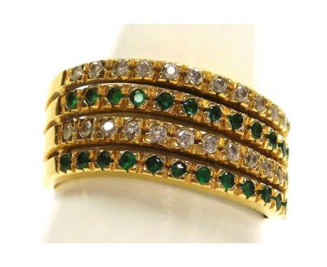 An emerald and diamond ring, pave set in a four band abstract yellow metal setting, stamped 18k, size Q, 4.9g.