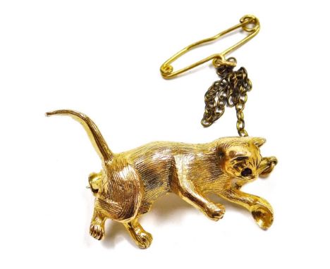 A 9ct gold cat brooch, set with ruby coloured eyes, on a safety chain as fitted, 5.8g.