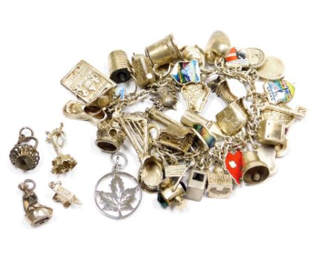 A silver oval link charm bracelet, with forty two silver and white metal charms, English, European and World as fitted, on a 