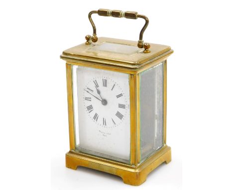 A brass cased clock by Hewitt &amp; Son Paris, with a Roman numeric enamel dial, single barrel movement and typical case with