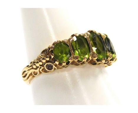 A 9ct gold and peridot five stone ring, in a graduated setting, size O, 4.4g.