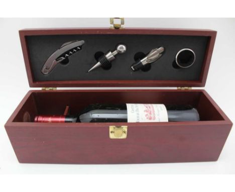 A MAHOGANY EFFECT PRESENTATION WINE GIFT BOX the lid fitted with four tools now containing a single bottle of Chateau Tour du