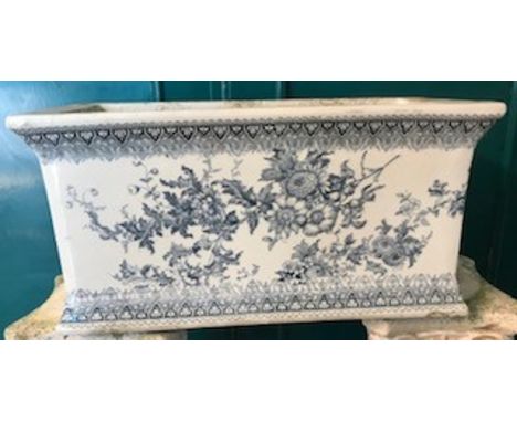 AN EDWARDIAN BLUE & WHITE GLAZED POTTERY CISTERN, 49cm wide x 24cm high, together with a pair of cast iron wall bracketsCondi