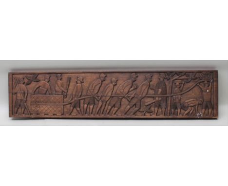 A CARVED WOOD PANEL DEPICTING SLAVE WORKERS HAULING AN IMMENSE BLOCK, with rope extending through the scene, watched over by 