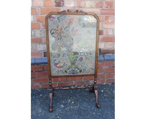 AN EARLY 20TH CENTURY MAHOGANY FRAMED FIRE SCREEN scroll and acanthus leaf crest, on cabriole trestle feet, inset a woolwork 