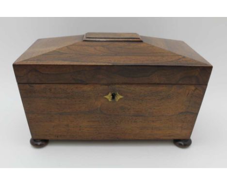 A 19TH CENTURY REGENCY DESIGN ROSEWOOD TEA CADDY of sarcophagus design, the hinged lid opens to reveal two lidded canisters a