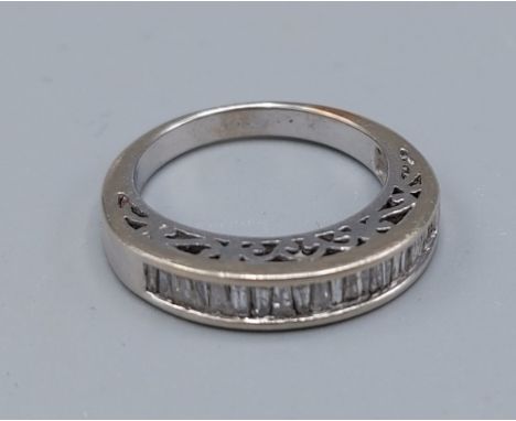 A white gold half eternity ring set with baguette diamonds channel set, ring size N, 5.2gms 